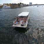 Party boat anchored on the sandbar in Fort Lauderdale for a quick cool-down swim, as viewed from a drone